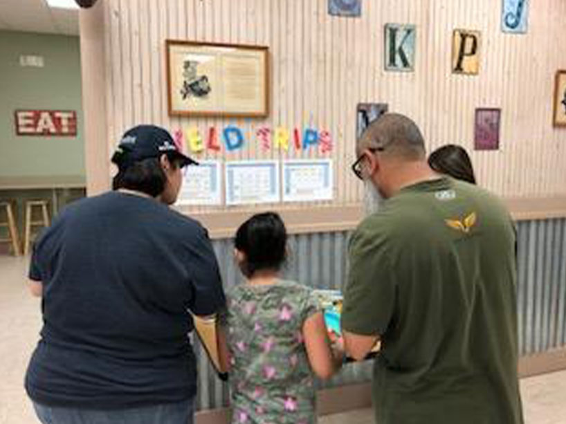 Parents with their child at Kid's Resort in Richmond, TX
